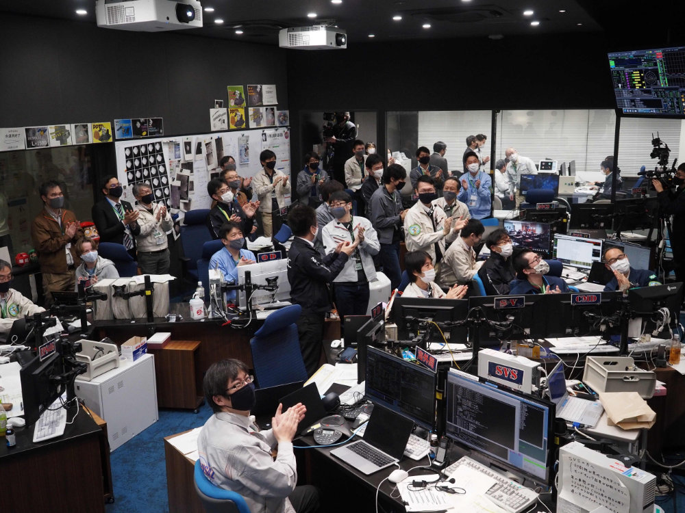 Hayabusa-2 project members in the mission control room watching over the live streaming about the fireball phase of the re-entry capsule in Sagamihara, Kanagawa prefecture. (JAXA photo via AFP)