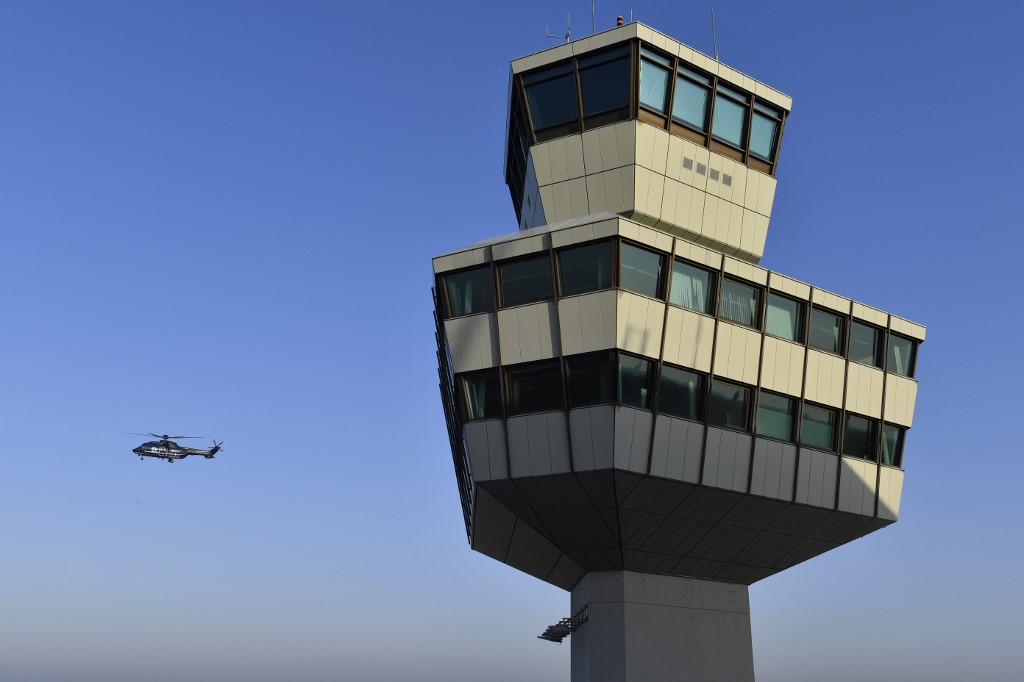 A helicopter of the German Federal Police flies near the control tower during the closing ceremony for Tegel 'Otto Lilienthal' Airport, in Berlin on November 8, 2020. (File/AFP)