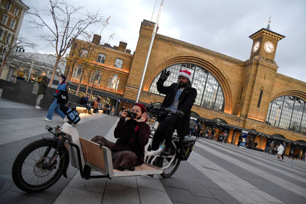 Travellers walk outside of King's Cross station in London on December 20, 2020 as the British government imposed a stricter tiered set of restrictions amid the COVID-19 pandemic. (REUTERS/Toby Melville)