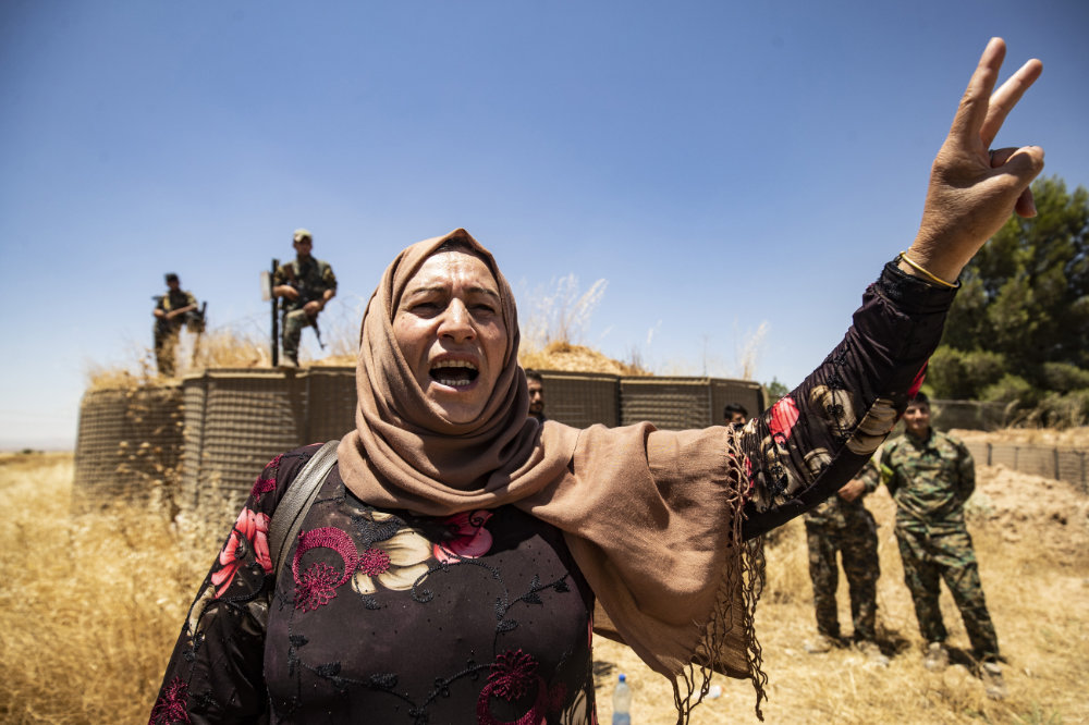 A Syrian Kurdish woman joins a demonstration in Hasakeh province on June 27, 2020, to protest Turkish deadly offensives in the northeastern areas of the country. (AFP file photo)