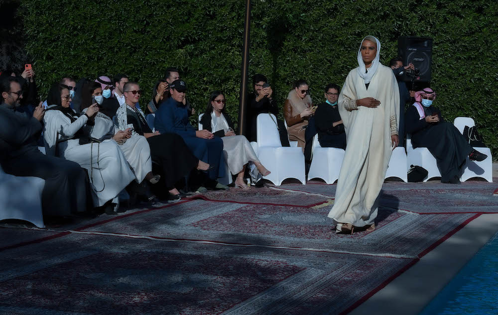 Models walk the runway showcasing the unique styles of the ‘Khaleeki Chic’ abaya line. Each abaya uses traditional Saudi cultural influence combined with modern colors and textures to create the international abaya for all women to wear. (AN Photo/Basheer Saleh)