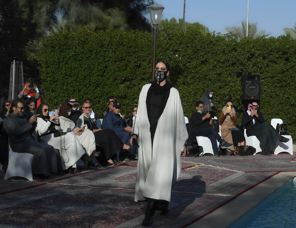 Models walk the runway showcasing the unique styles of the ‘Khaleeki Chic’ abaya line. Each abaya uses traditional Saudi cultural influence combined with modern colors and textures to create the international abaya for all women to wear. (AN Photo/Basheer Saleh)