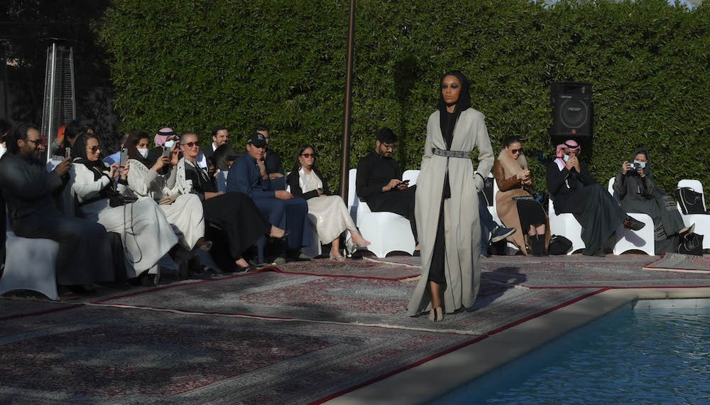 Models walk the runway showcasing the unique styles of the ‘Khaleeki Chic’ abaya line. Each abaya uses traditional Saudi cultural influence combined with modern colors and textures to create the international abaya for all women to wear. (AN Photo/Basheer Saleh)