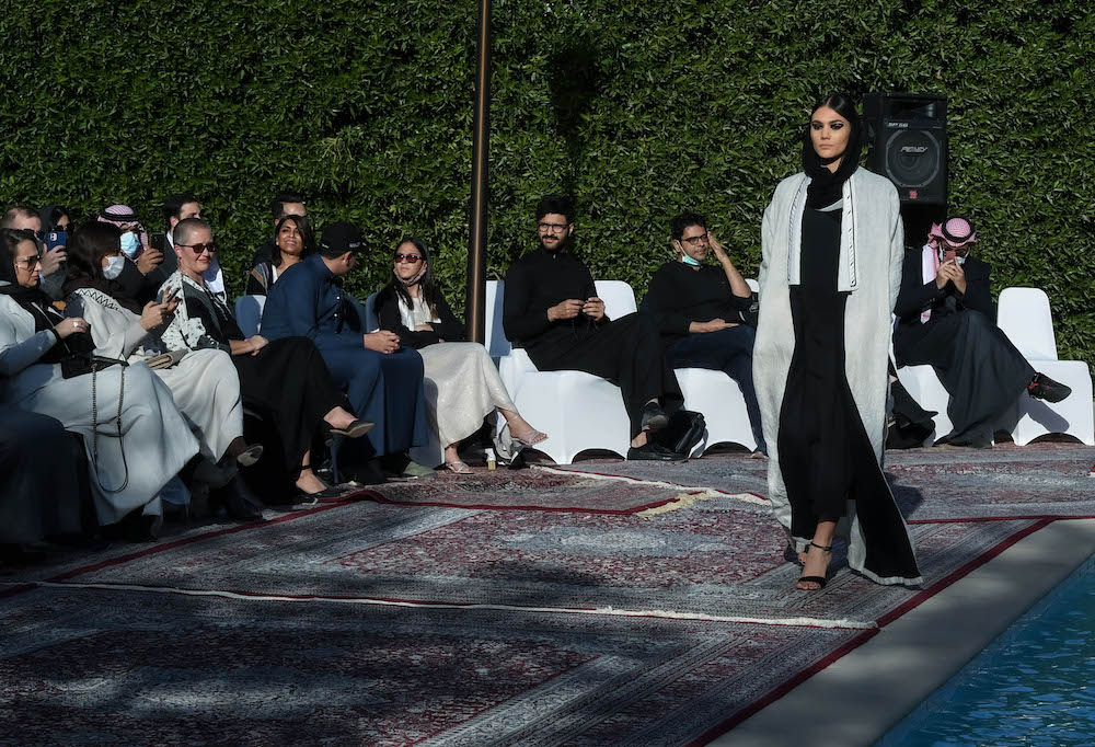 Models walk the runway showcasing the unique styles of the ‘Khaleeki Chic’ abaya line. Each abaya uses traditional Saudi cultural influence combined with modern colors and textures to create the international abaya for all women to wear. (AN Photo/Basheer Saleh)