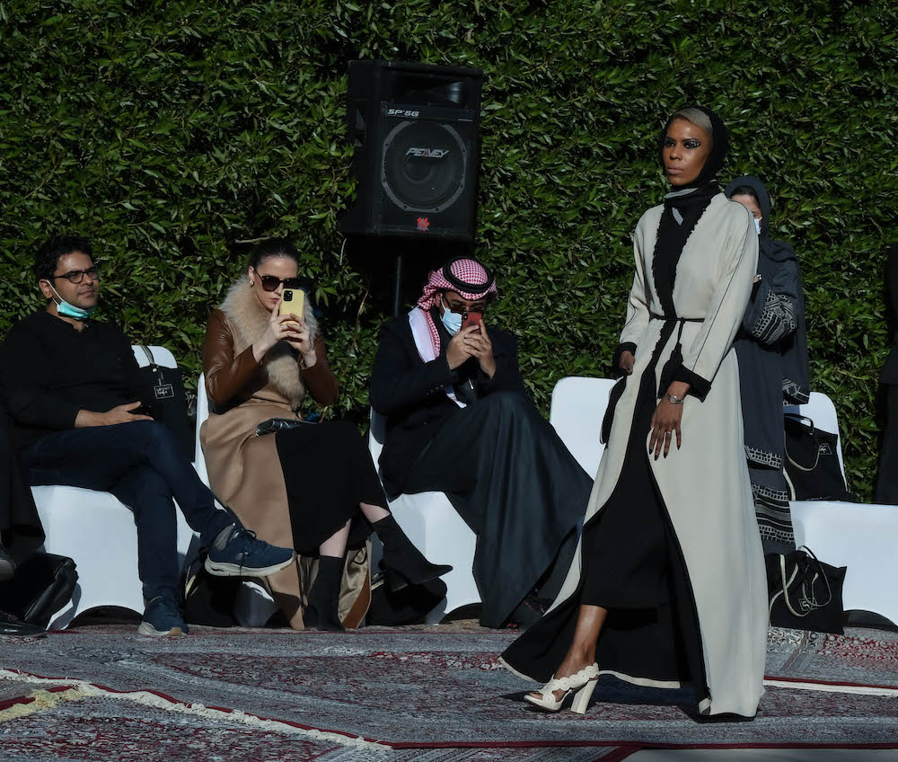 Models walk the runway showcasing the unique styles of the ‘Khaleeki Chic’ abaya line. Each abaya uses traditional Saudi cultural influence combined with modern colors and textures to create the international abaya for all women to wear. (AN Photo/Basheer Saleh)