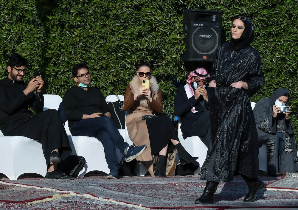 Models walk the runway showcasing the unique styles of the ‘Khaleeki Chic’ abaya line. Each abaya uses traditional Saudi cultural influence combined with modern colors and textures to create the international abaya for all women to wear. (AN Photo/Basheer Saleh)