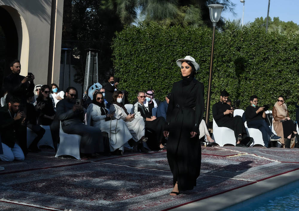 Models walk the runway showcasing the unique styles of the ‘Khaleeki Chic’ abaya line. Each abaya uses traditional Saudi cultural influence combined with modern colors and textures to create the international abaya for all women to wear. (AN Photo/Basheer Saleh)