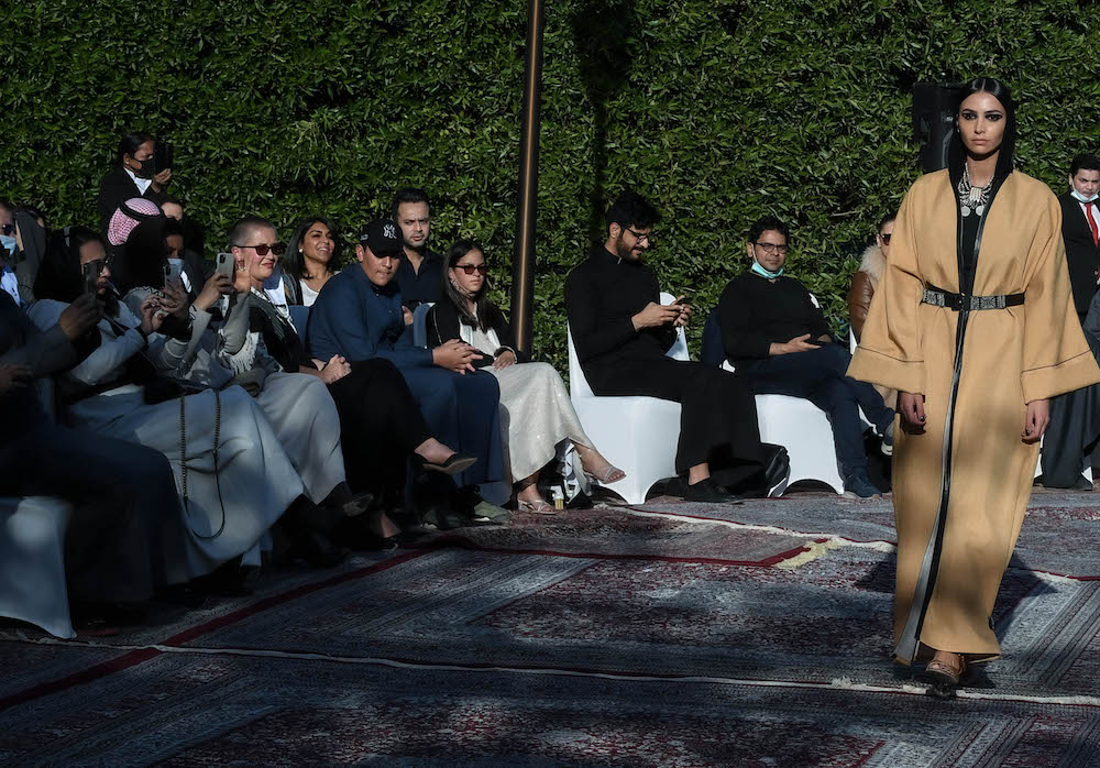 Models walk the runway showcasing the unique styles of the ‘Khaleeki Chic’ abaya line. Each abaya uses traditional Saudi cultural influence combined with modern colors and textures to create the international abaya for all women to wear. (AN Photo/Basheer Saleh)