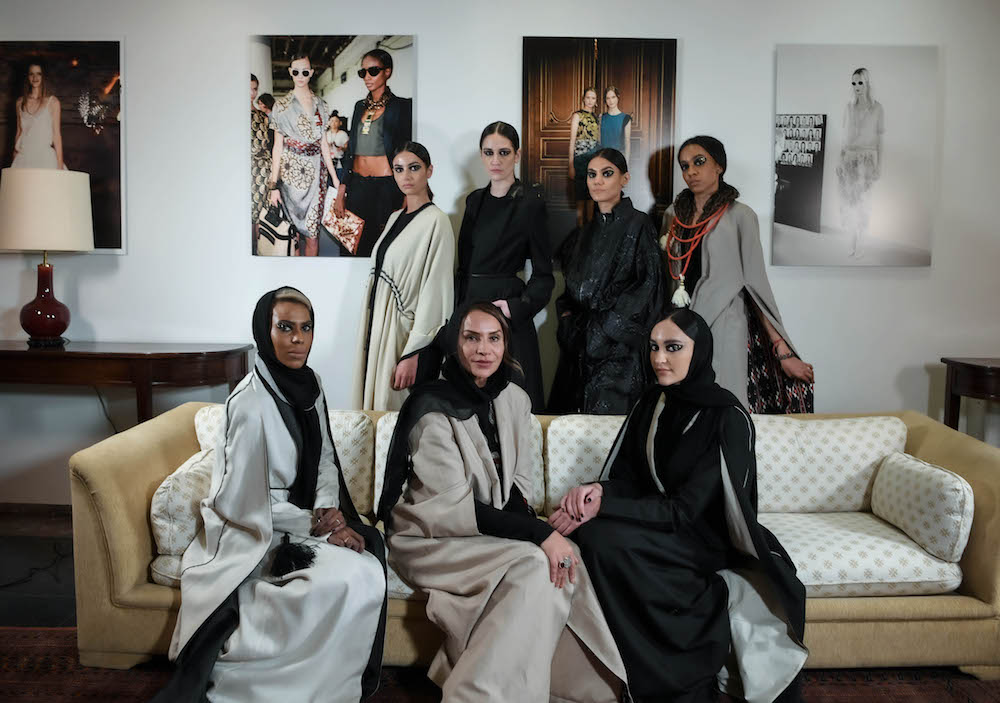 Creative director Princess Safia Hussein Guerras (center) sits next to her daughter Princess Hannah Al-Faisal (right) and the rest of the models following the end of the show. (AN Photo/Basheer Saleh)