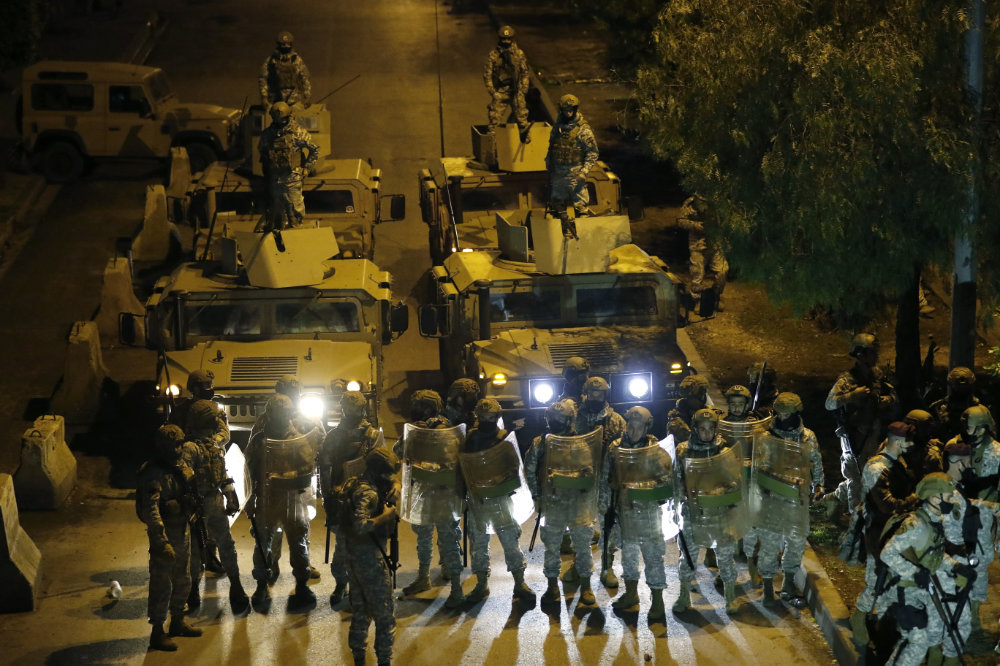 Lebanese soldiers prepare to move protesters from streets during a protest in Tripoli, Lebanon, on  Jan. 29, 2021 gainst deteriorating living conditions and strict coronavirus lockdown measures. (AP Photo/Hussein Malla) 