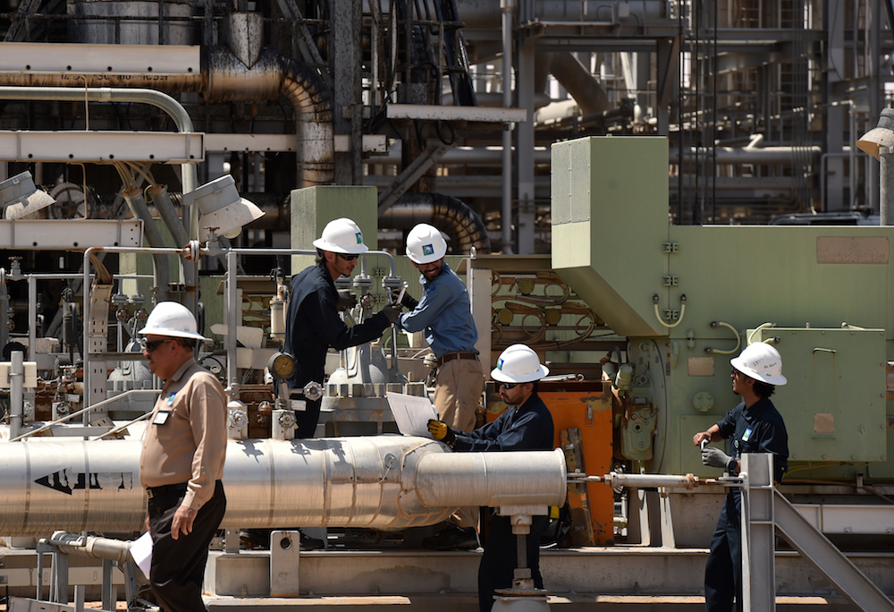 Employes of Aramco oil company at work in Saudi Arabia's Khurais oil processing plant. Since Jan. 5, when Prince Abdul Aziz bin Salman, the Kingdom’s energy minister, announced a surprise extra production cut of 1 million barrels per day (bpd), Brent is up around 15 percent. (AFP/File Photo)