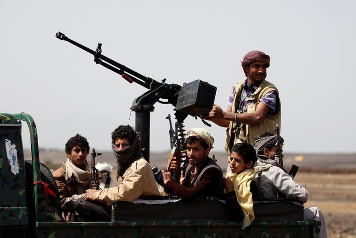 Houthi fighters ride on the back of a patrol truck as they secure the site of a pro-Houthi tribal gathering in a rural area near Sanaa, Yemen. (File/Reuters)