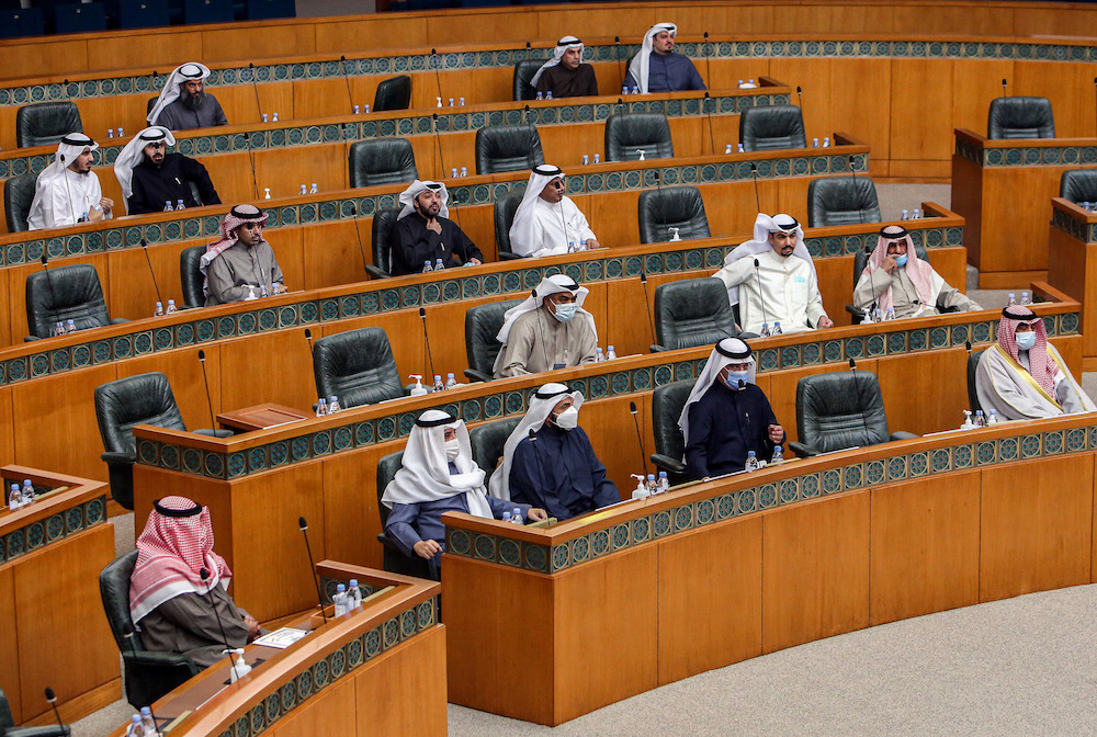 Kuwaiti members of parliament attend a special session following-up on measures undertaken by the government of limit the spread of COVID-19 coronavirus disease, at the National Assembly headquarters in Kuwait City on Feb. 16, 2021. (AFP)