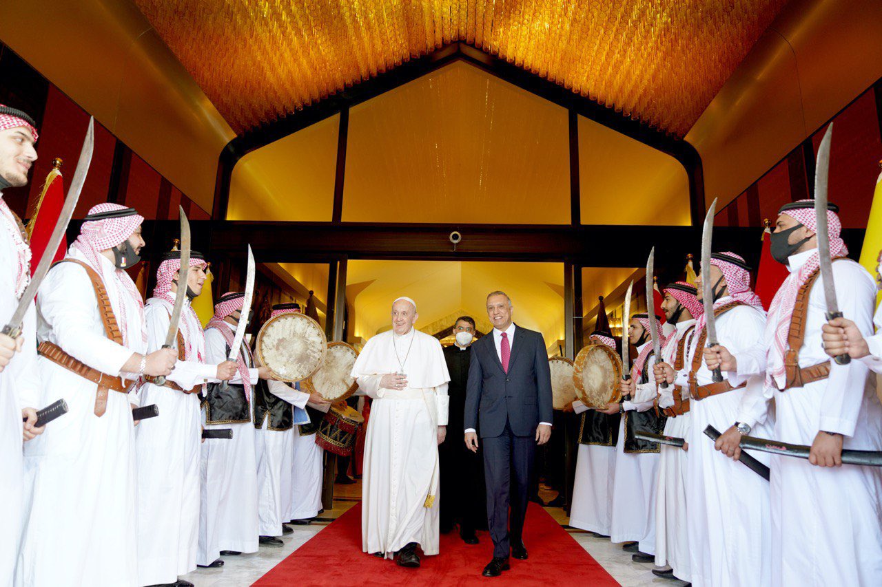 Pope Francis and the Iraqi prime minister Mustafa Al-Kadhimi are greeted by traditional dancing shortly after the pontiff's arrival in Iraq. (@IraqiPMO)