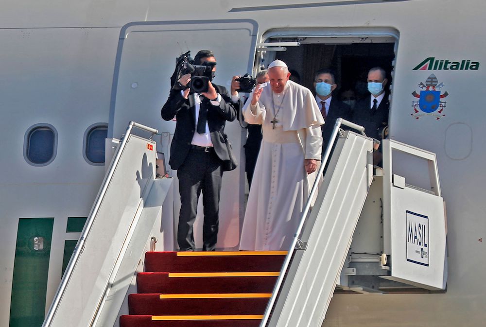 Pope Francis bows in farewell to his hosts before boarding his Alitalia Airbus A330 aircraft as he departs from the Iraqi capital's Baghdad International Airport on March 8, 2021. (AFP)