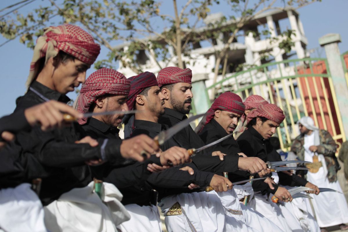 Knife-wielding Houthi supporters demonstrate at a rally n Sanaa, Yemen, on March 26, 2021. (AP Photo/Hani Mohammed)