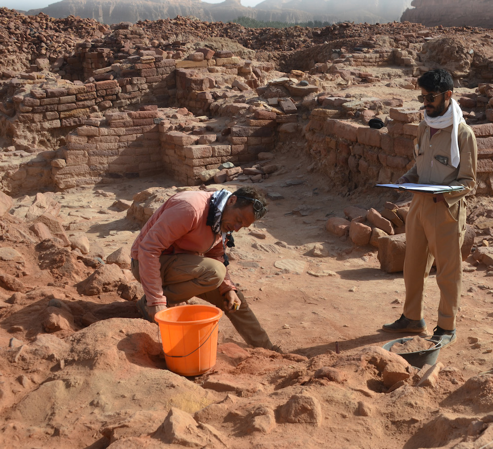 An excavation team director of the Oxford Archaeology landscape survey project excavates a mustatil, a type of rectangular structure probably for ritual purposes, that is among the oldest large-scale stone structures in Arabia. (Supplied)