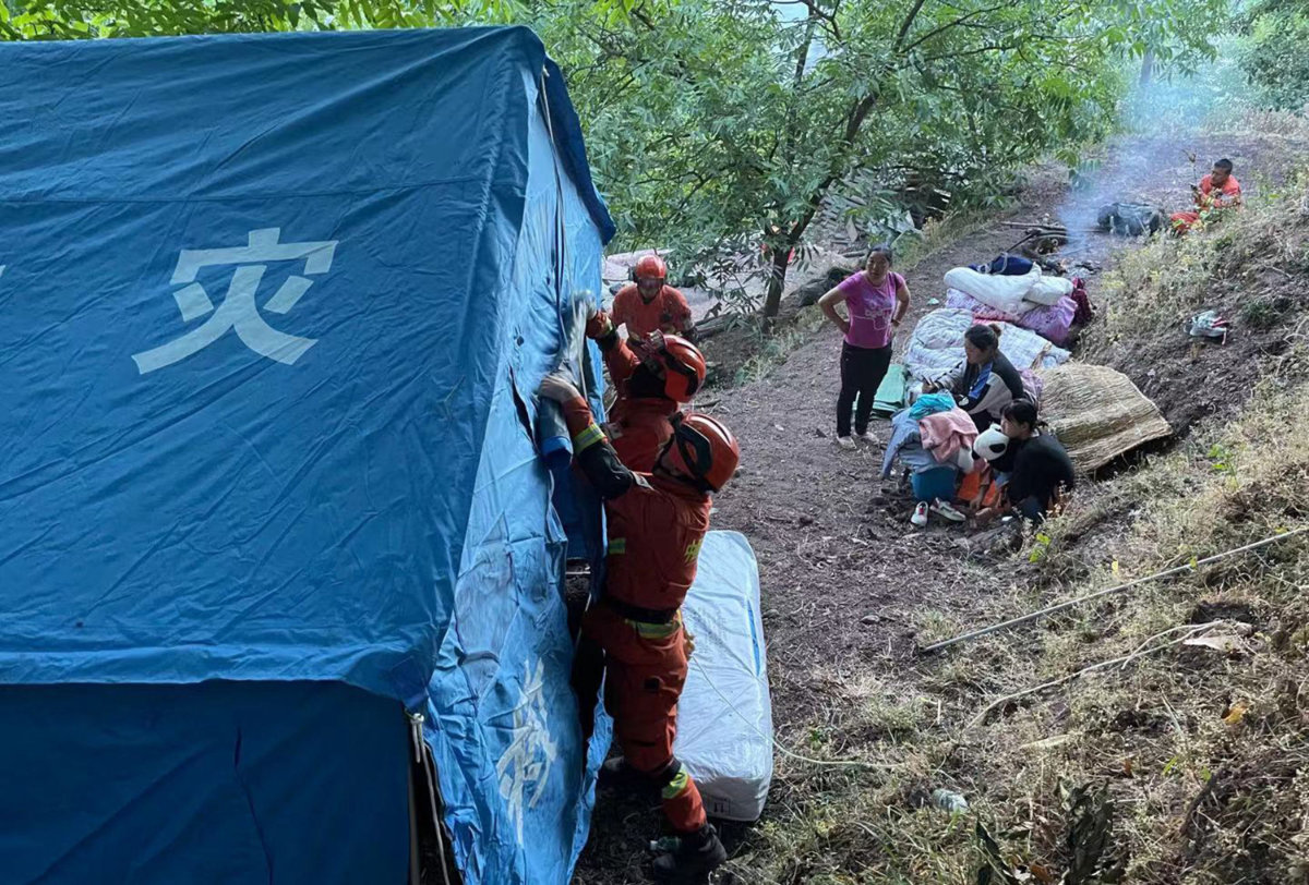 Firefighters set up temporary tents for people displaced by an overnight earthquake in Yangbi County in China's southwest Yunnan province on May 22, 2021. (AFP)