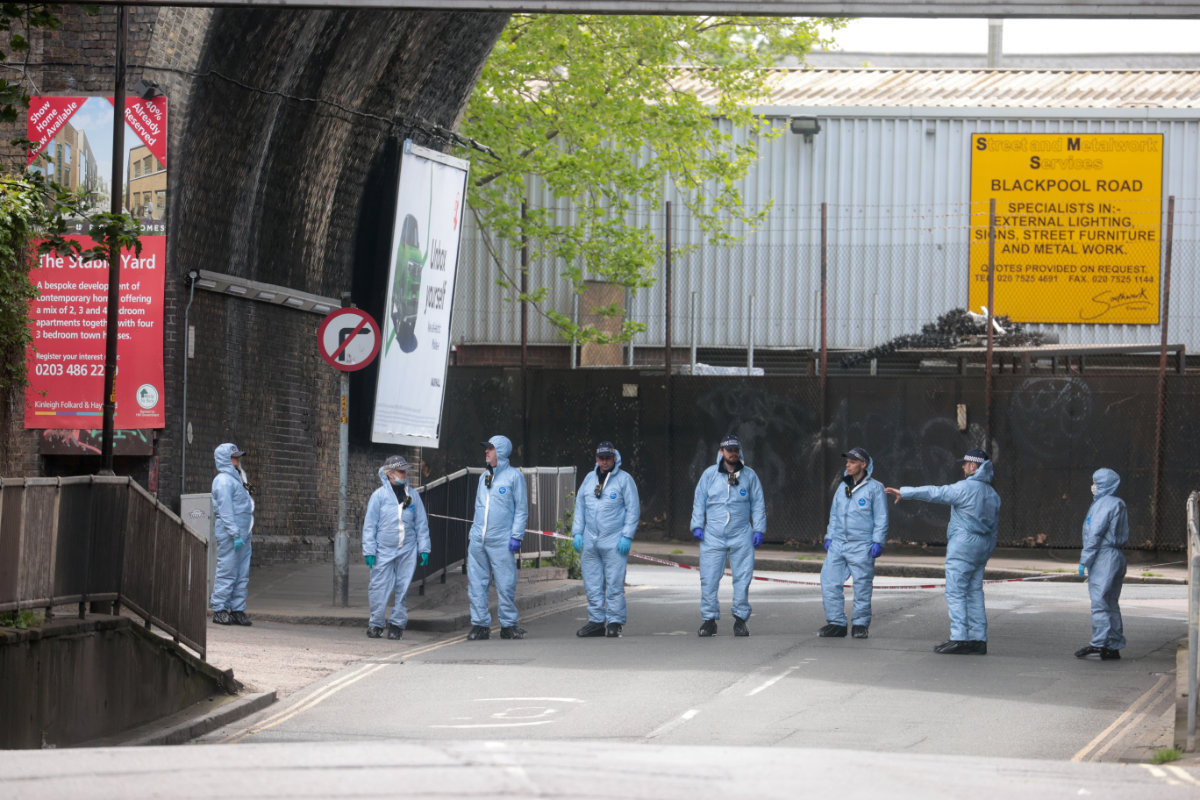 Forensic officers stand at the area after Sasha Johnson, a BLM activist, was shot in an early morning attack near her home in Peckham, London, on May 24, 2021. (REUTERS File Photo)