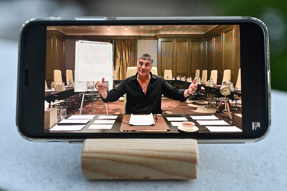 A photograph taken on May 26, 2021 in Istanbul shows Sedat Peker speaking on his YouTube channel on a mobile phone. (AFP)