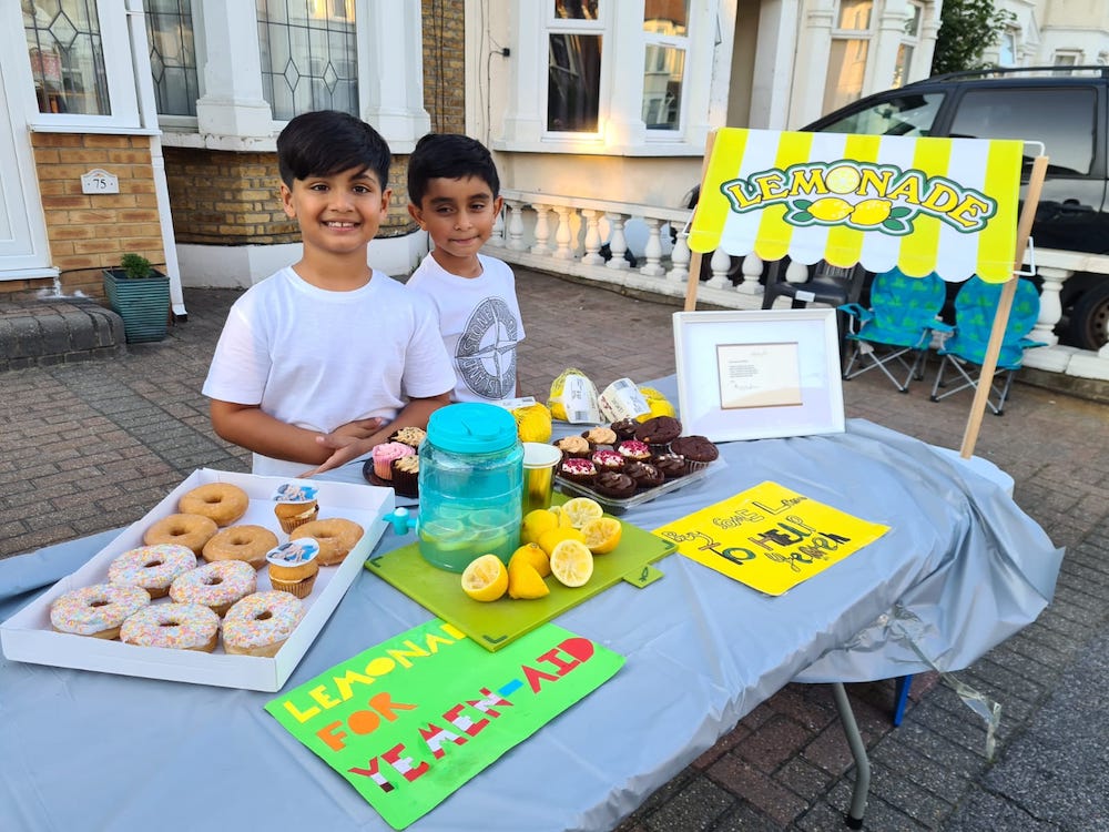 Best friends Ayaan Moosa and Mikaeel Ishaaq set up their homemade lemonade stand and managed to raise £140,000 for Yemen. (Supplied)