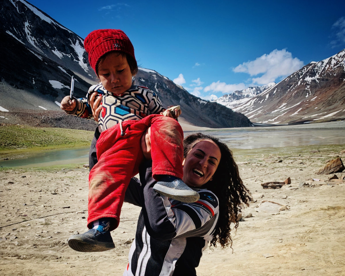 Asil Ozbay with a child from a family she met during her travel through Asia. (Supplied)