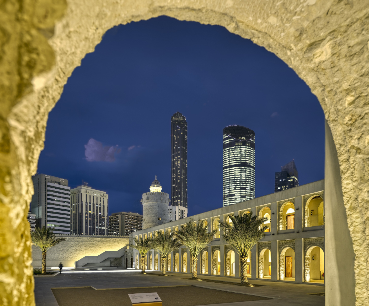 A close up architectural shot of a Qasr Al Hosn arch, showcasing the corridors of the attraction and the iconic tower, illuminated by bright lights during the night time. (Supplied)