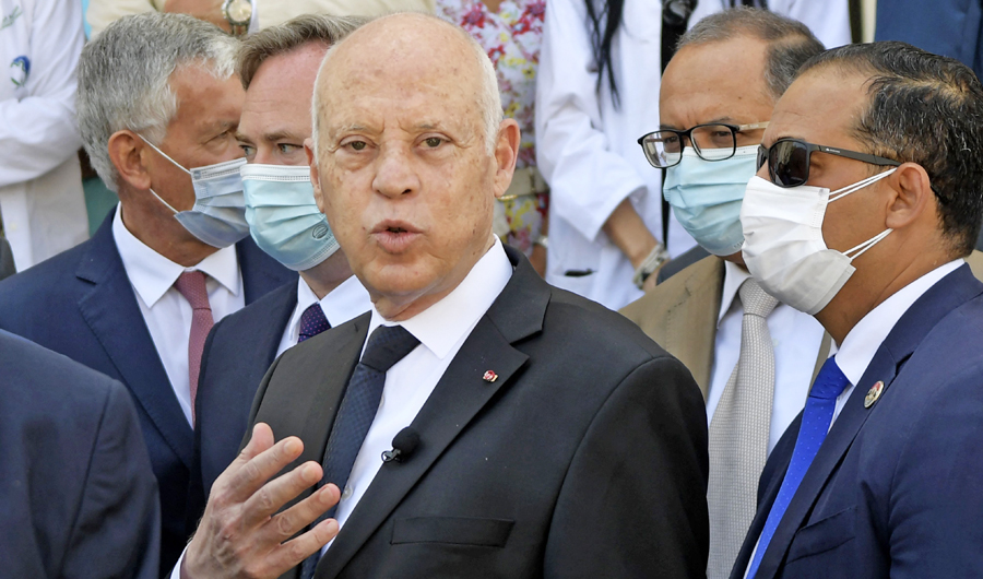 Tunisia's President Kais Saied speaks with reporters in the capital Tunis on July 23, 2021, during a ceremony to receive French aid to combat COVID-19 in the presence of France's minister (unseen). (AFP)