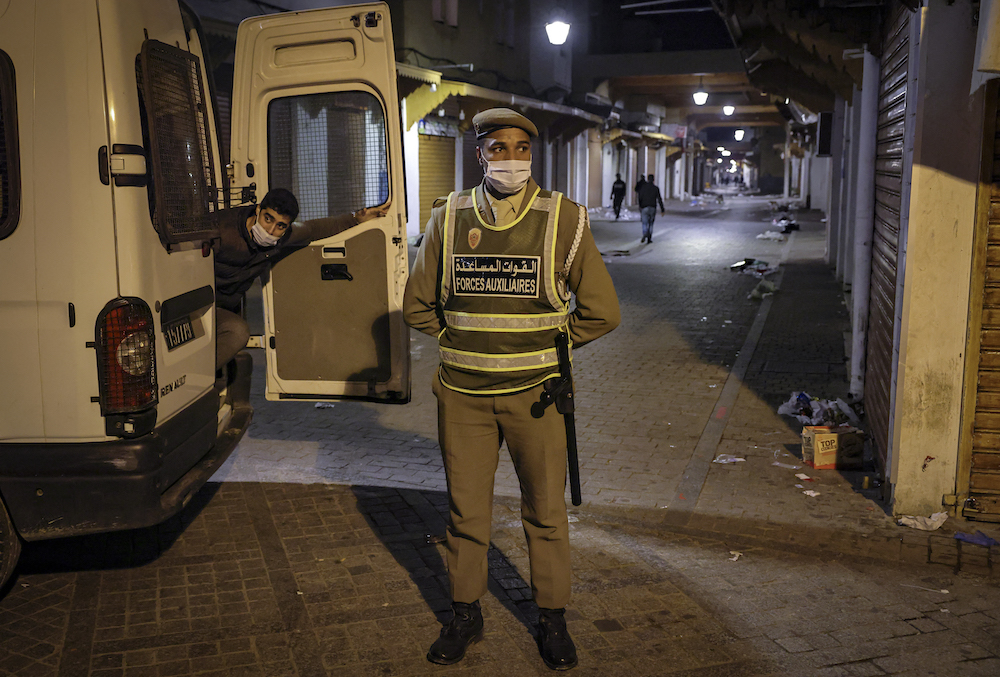 A member of Morocco’s Interior Ministry Auxiliary Forces stands next to a vehicle while on patrol in a neighborhood, enforcing the reimposed lockdown due to the COVID-19 coronavirus pandemic in the capital Rabat’s old city. (File/AFP)