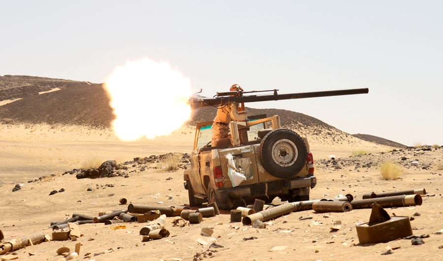 A Yemeni government fighter fires a vehicle-mounted weapon at a frontline position during fighting against Houthi fighters in Marib, Yemen March 9, 2021. (REUTERS)