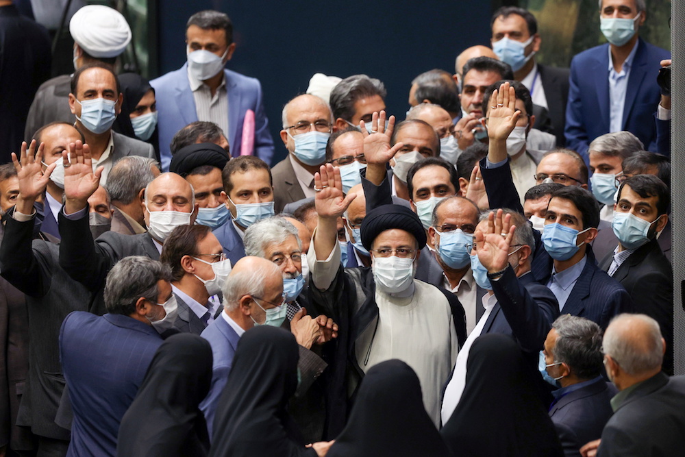 Iran’s new President Ebrahim Raisi waves during his swearing-in ceremony at the parliament in Tehran, Iran, Aug. 5, 2021. (Majid Asgaripour/WANA/via Reuters)