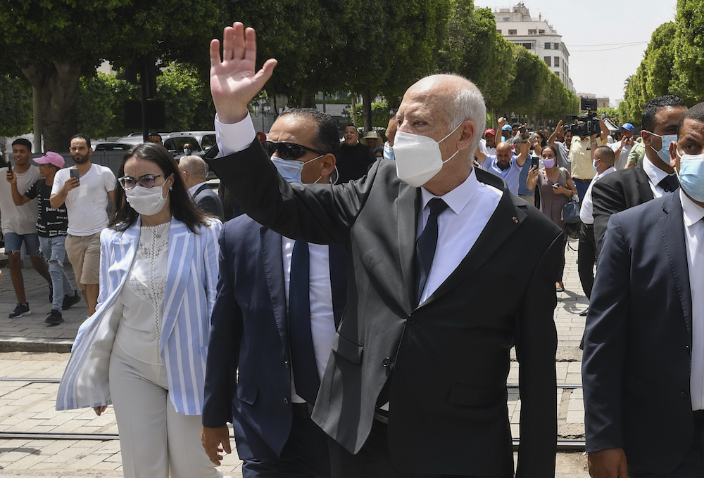 Tunisian President Kais Saied waves to bystanders as he strolls along the avenue Bourguiba in Tunis, Tunisia. (File/Slim Abid/Tunisian Presidency via AP)