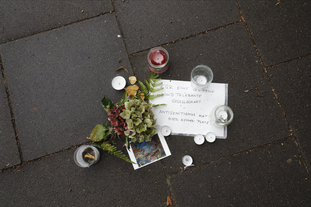 Flowers, candles and a message reading 