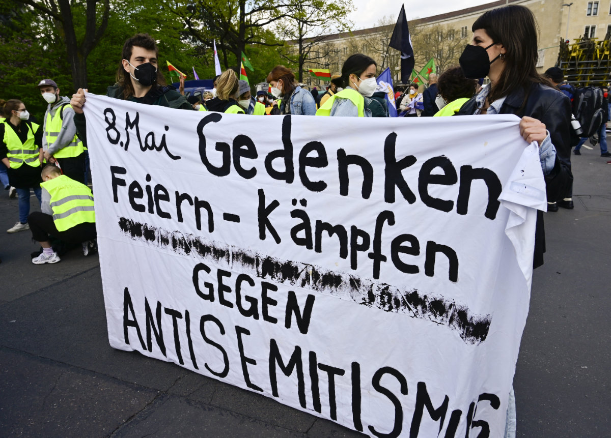 emonstrators hold a banner reading "May 8th, commemoration, celebrate, fight against antisemitism" during a protest against the presence of far-right elements in the German police and other security services in Berlin May 8, 2021. (AFP)