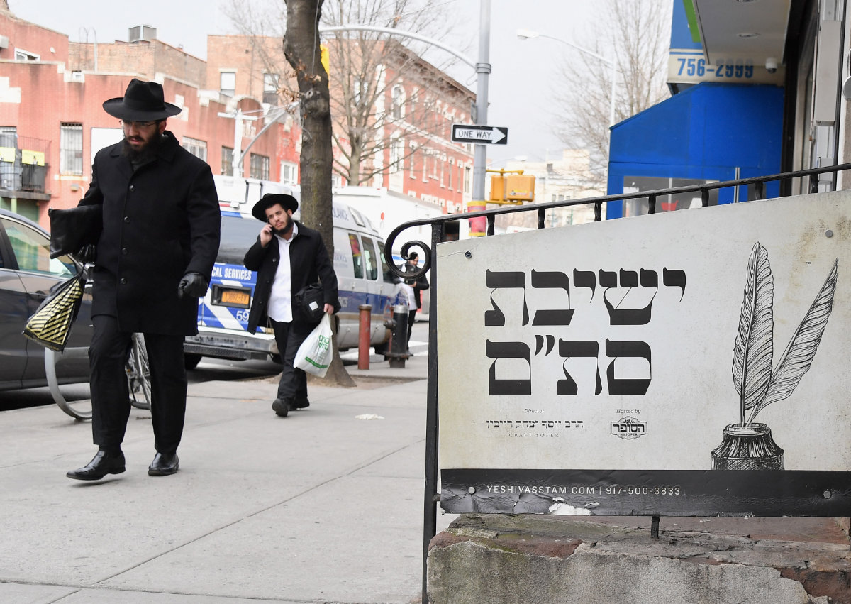 Orthodox Jewish men walk in the Brooklyn neighborhood of Crown Heights on February 27, 2019 in New York following a spate of anti-Semitic attacks that has brought back painful memories. (AFP)