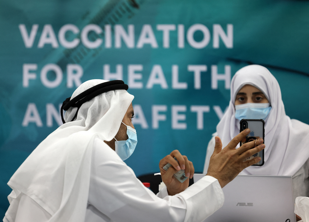 A man registered before receiving a dose of vaccine against the coronavirus at a vaccination center set up at the Dubai International Financial Center. (File/AFP)