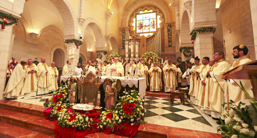 Pierbattista Pizzaballa, Latin Patriarch of Jerusalem, leads a Christmas day mass at the Church of Nativity during celebrations in Bethlehem in the Israeli-occupied West Bank on Saturday. (AFP)