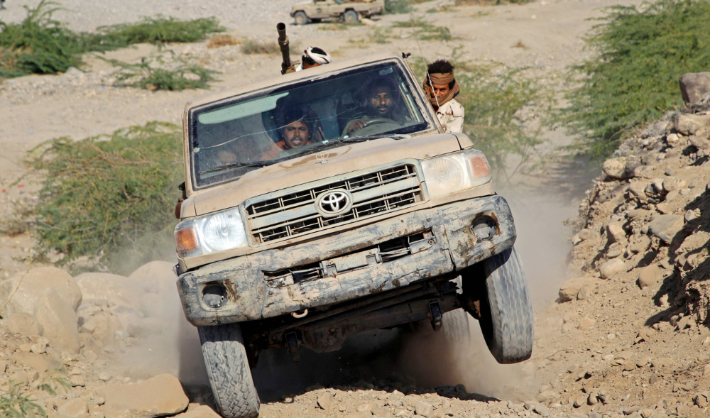 Fighters loyal to Yemen's government patrol in the Maqbana area of Yemen's southwestern province of Taez, on December 13, 2021. (AFP)