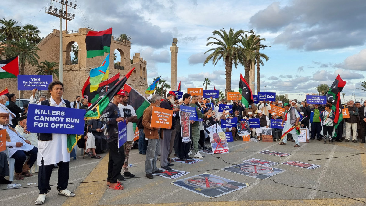 Libyans protest at Martyrs’ Square in the capital Tripoli after Saif Al-Islam Qaddafi, son of former dictator Muammar Qaddafi, announced his candidacy in the upcoming presidential election. (AFP)