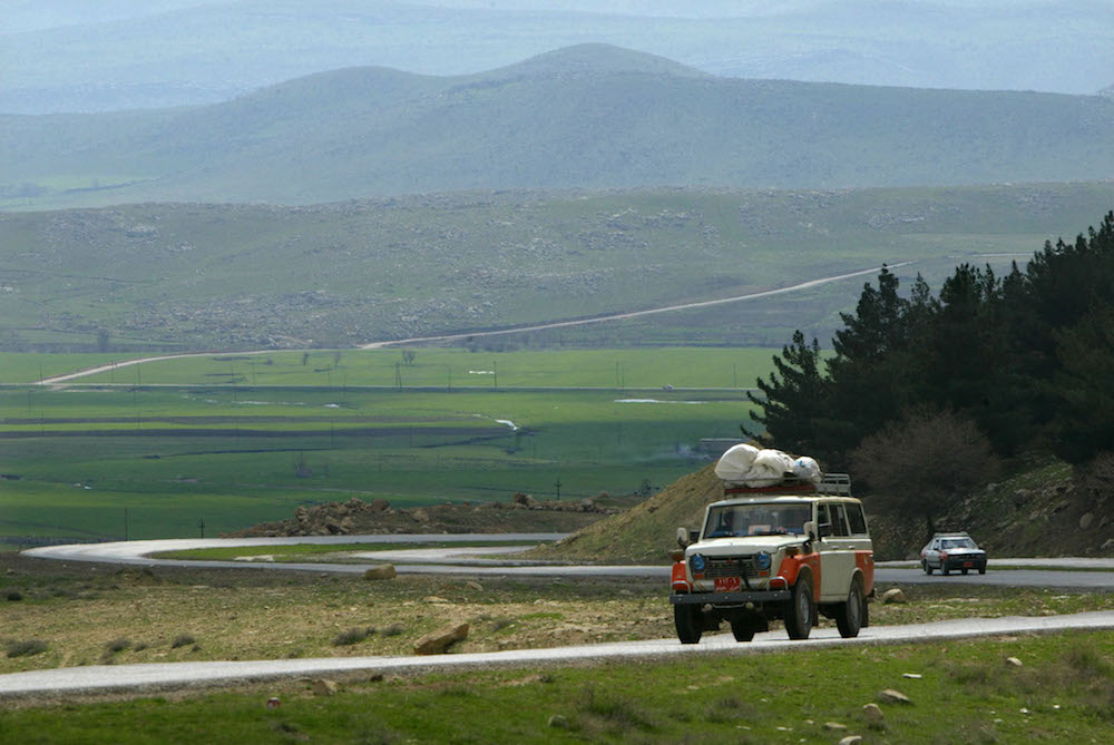 Iraqi Kurds drive a vehicle in the Kurdish town of Chamchamal on the Green Line (File/AFP)