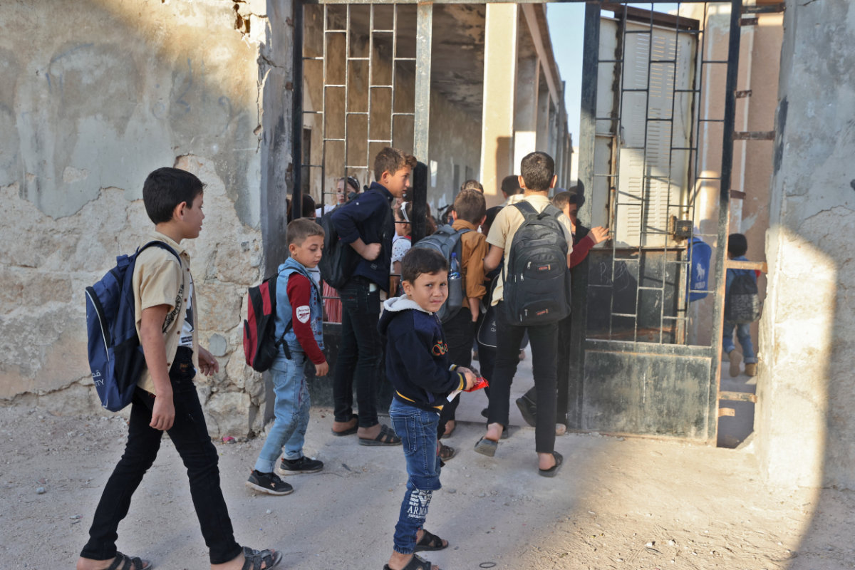 hildren attend the first day of school in a village in the countryside of Syria's northwestern Idlib province on Oct. 9, 2021. (AFP file)