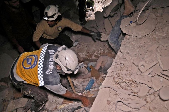 Syrian rescuers, known as White Helmets, recover bodies in Zardana, in the mostly rebel-held northern province of Idlib, following air strikes in the area late on June 7, 2018. (AFP file)