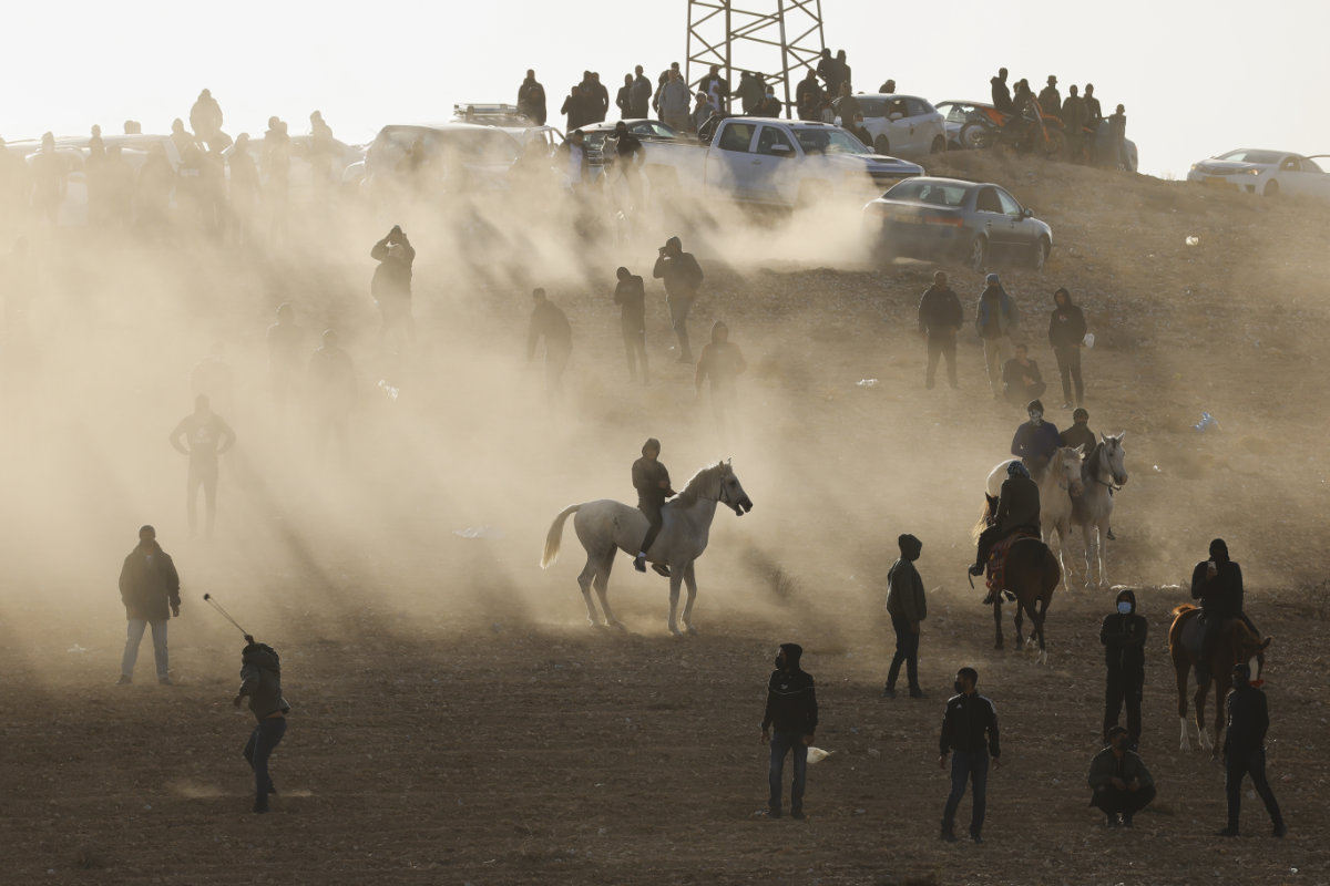 Bedouin protesters clash with Israeli forces over an afforestation project by the Jewish National Fund in the southern Israeli village of Sa'we al-Atrash in the Negev Desert on Jan. 13, 2022. (AP Photo/Tsafrir Abayov)