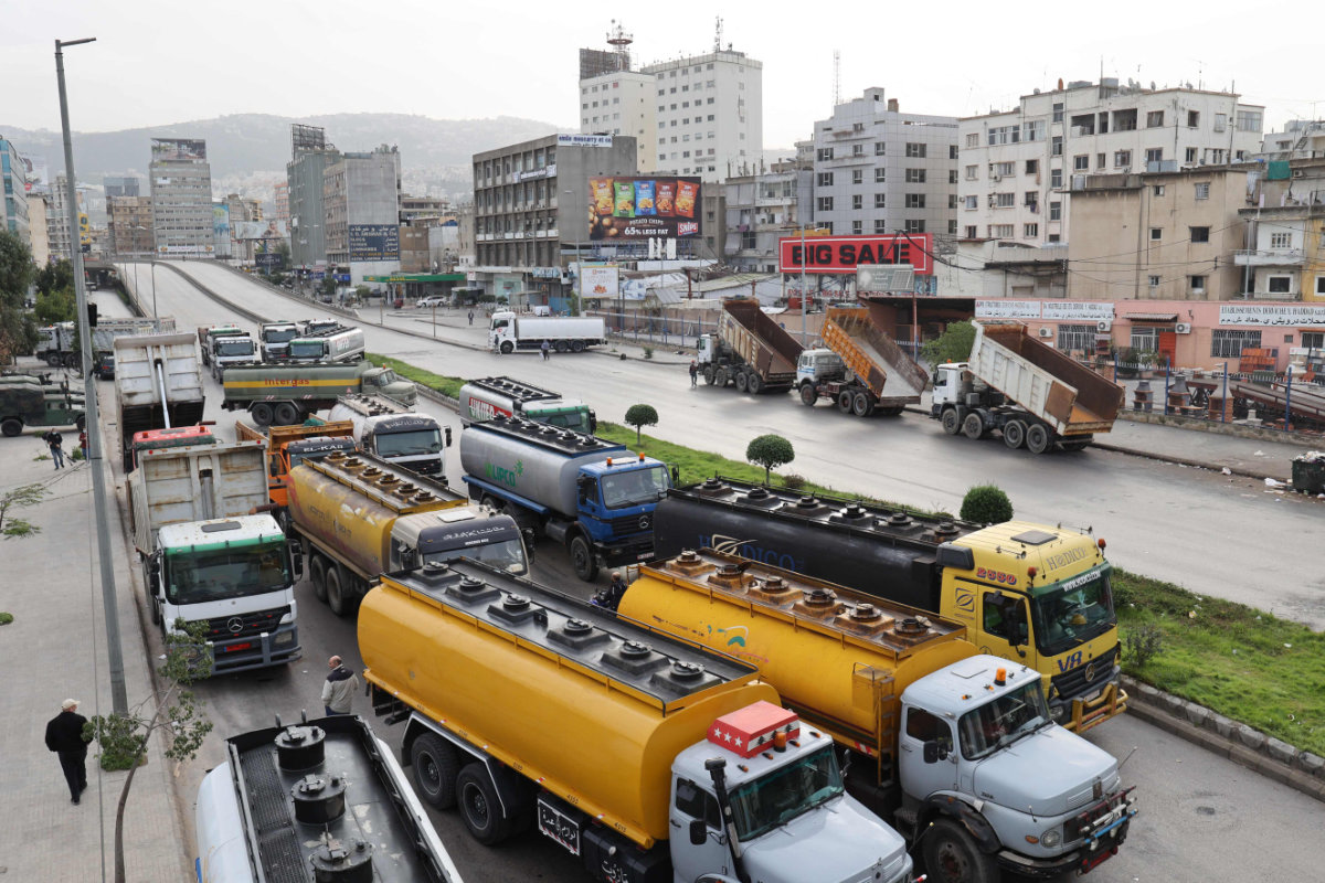 Fuel tankers block a road in Beirut during a general strike on Jan. 13, 2022 by public transport and workers unions over the country's economic crisis. (Anwar Amro / AFP) 