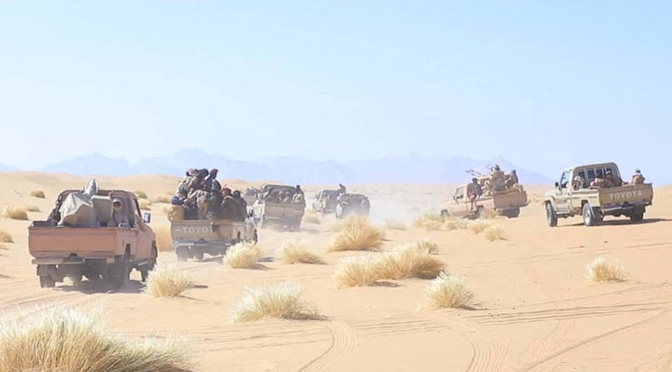 Yemeni government army soldiers ride on the back of pick-up trucks at the frontline of fighting against Houthis in Marib, Yemen. (Yemeni Armed Forces/Reuters)