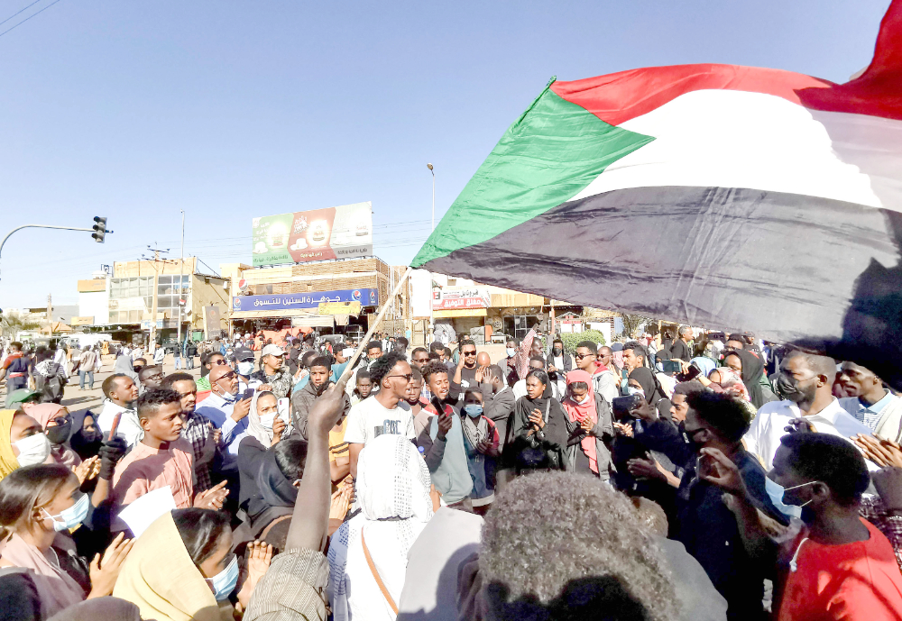 Young women and men take to the streets of Khartoum to protest against the killings of dozens in a crackdown since last year’s military coup. (AFP)