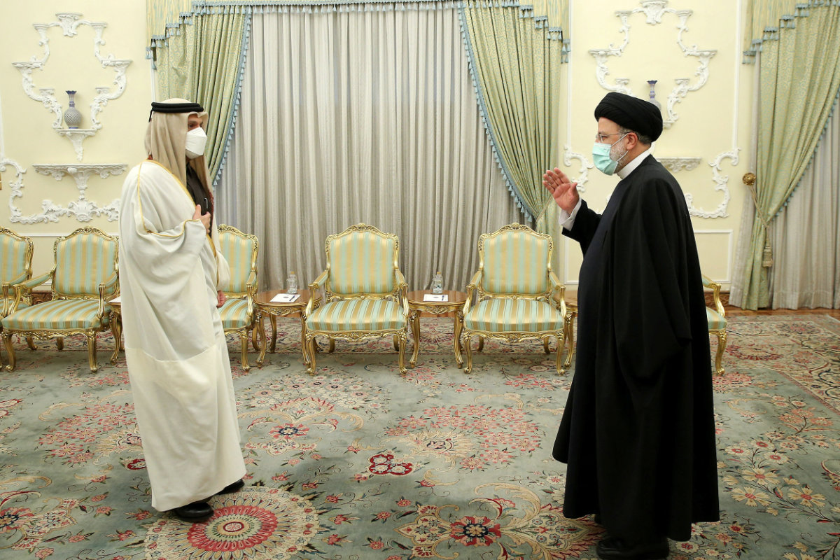 Iranian President Ebrahim Raisi greets Qatar's Deputy PM and Foreign Minister Mohammed bin Abdulrahman Al Thani for a meeting in Tehran on  Jan. 27, 2022. (Iranian Presidency Office/Handout via REUTERS)