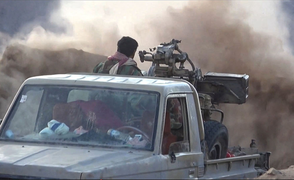 A Yemeni pro-government fighter fires at positions of the Iran-backed Houthi militia as they inch closer to the loyalists’ last northern bastion, the strategic city of Marib. (File/AFPTV/AFP)