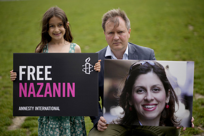 Richard Ratcliffe, husband of imprisoned British-Iranian Nazanin Zaghari-Ratcliffe, and their daughter Gabriella in Parliament Square, London, in September, 2021. (AP/File Photo)