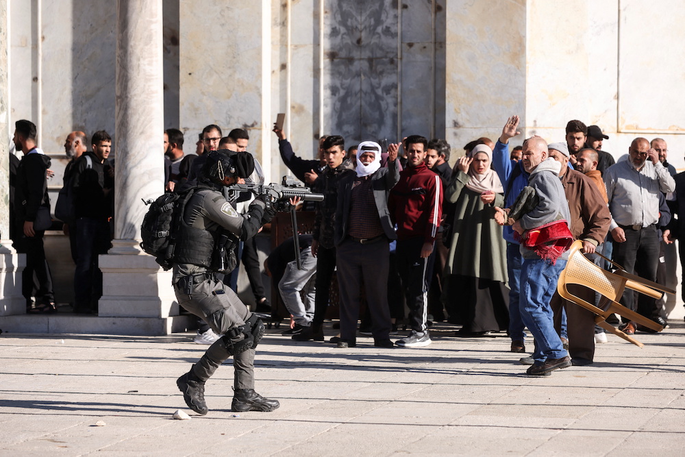 An Israeli security forces member moves in position during clashes with Palestinian protestors at the compound that houses Al-Aqsa Mosque. (Reuters)